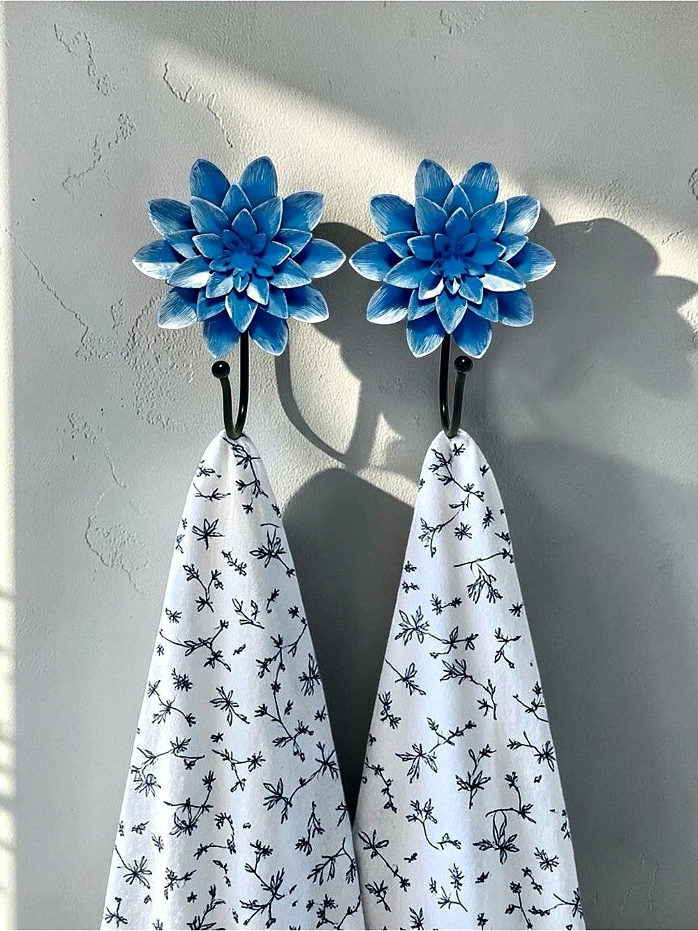 Distressed blue & white flower wall hooks, typically styled as layered dahlias